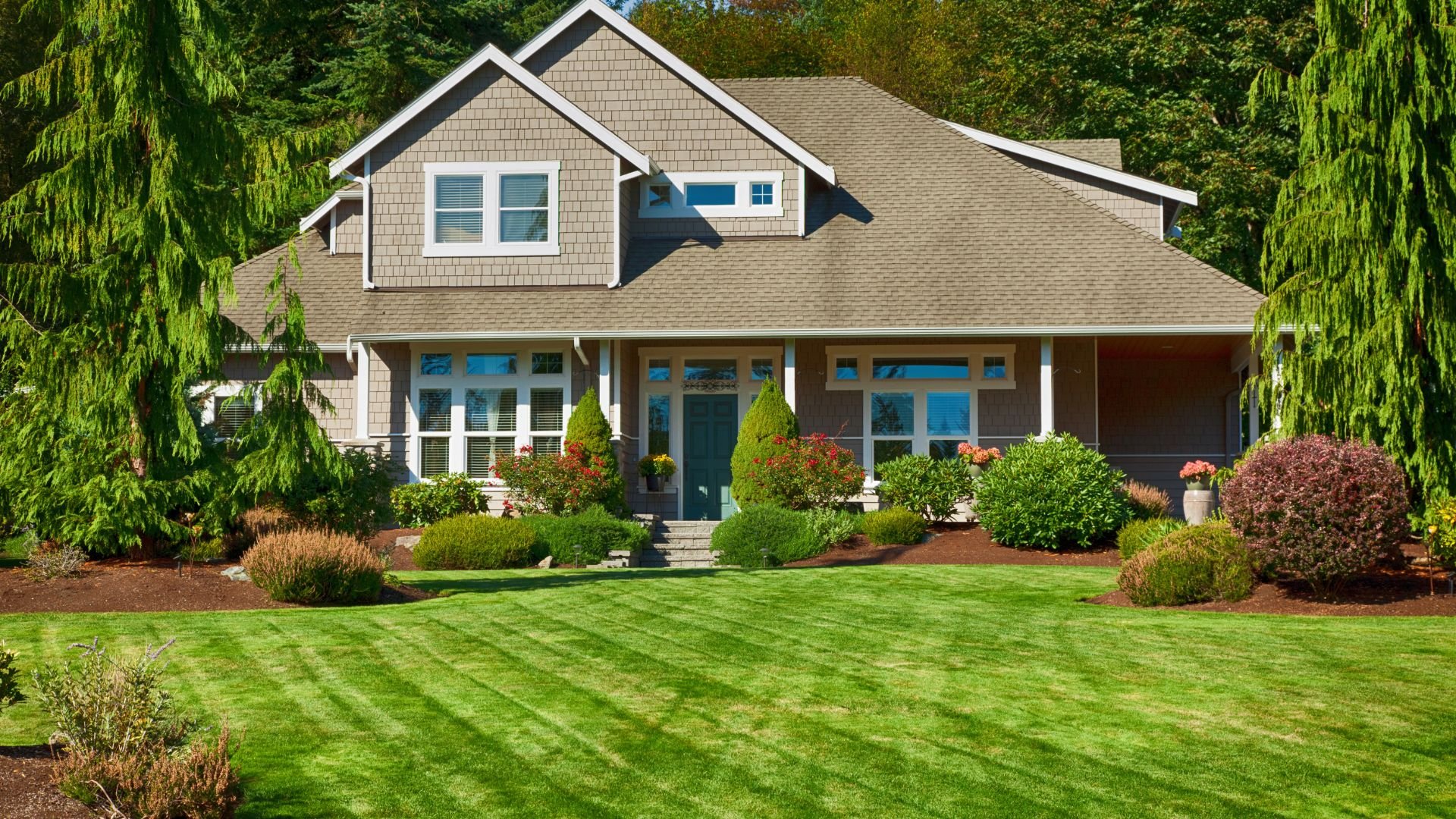 Well-manicured suburban home with pristine lawn and landscaped garden